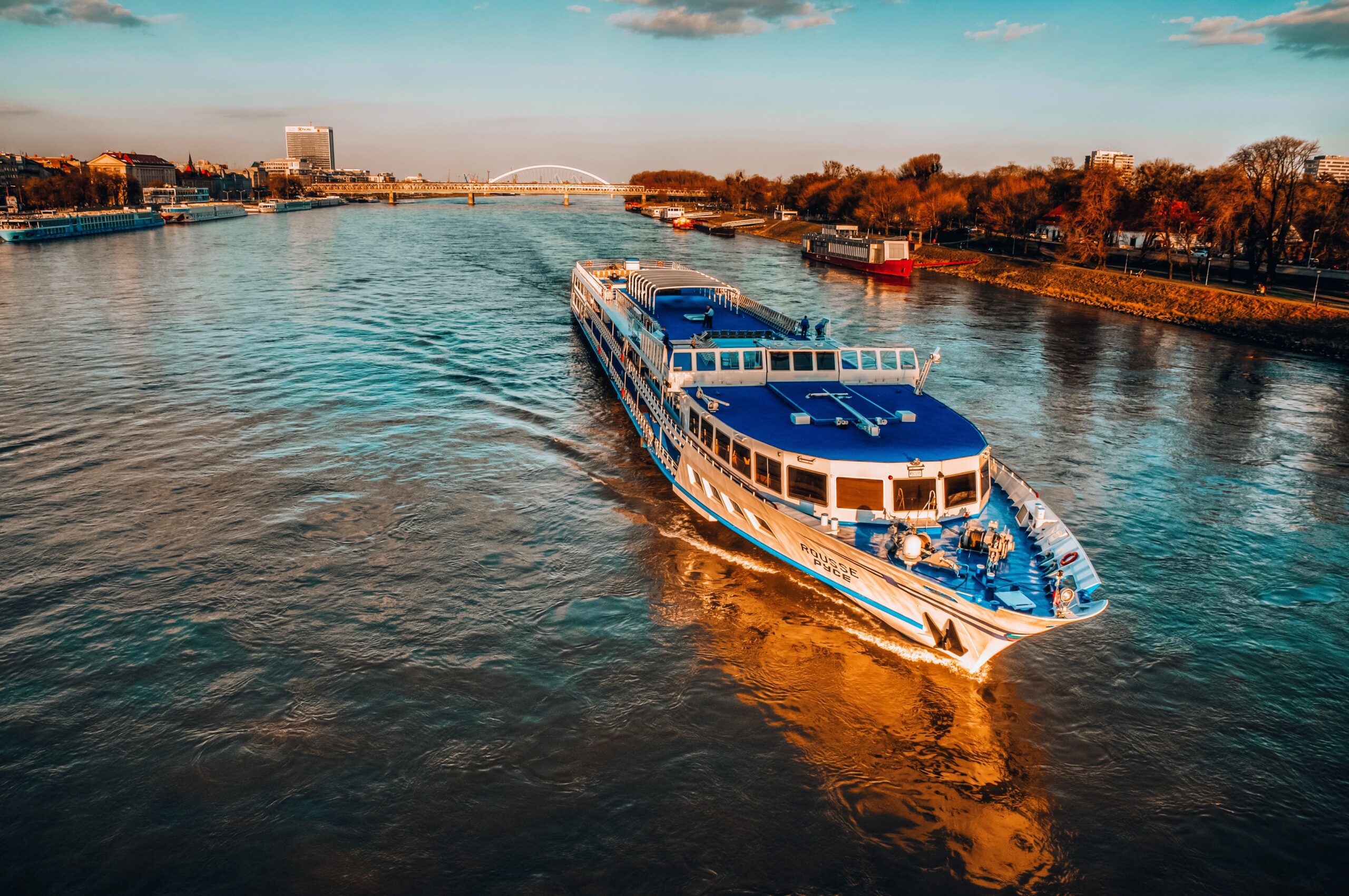 modern river cruise ship sailing scenic Rhine River in Europe.