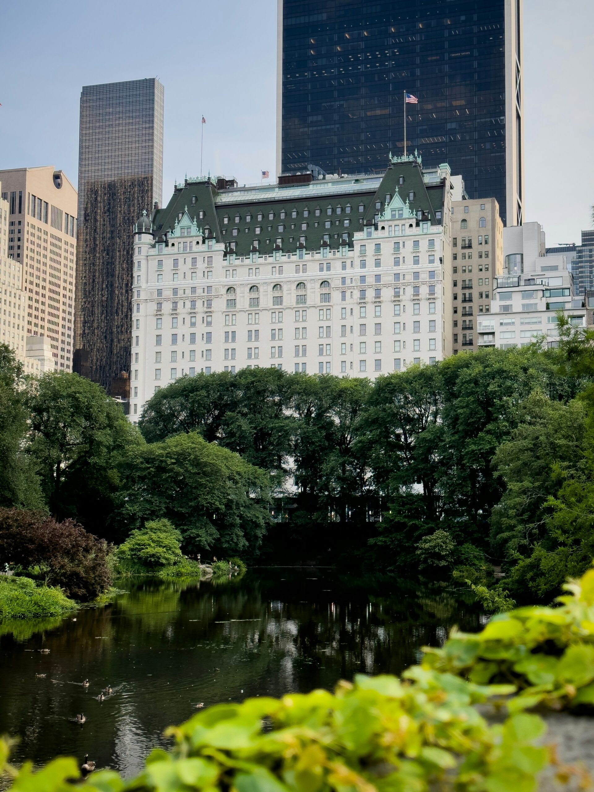 Gapstow Bridge in Central Park framed by autumn leaves and Manhattan skyline