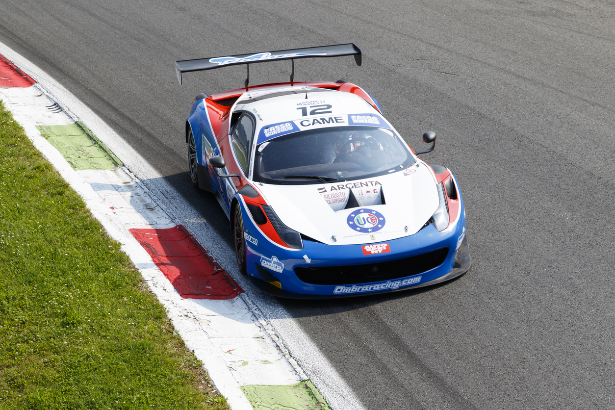 Ferrari cars racing at the historic Monza circuit in Italy.