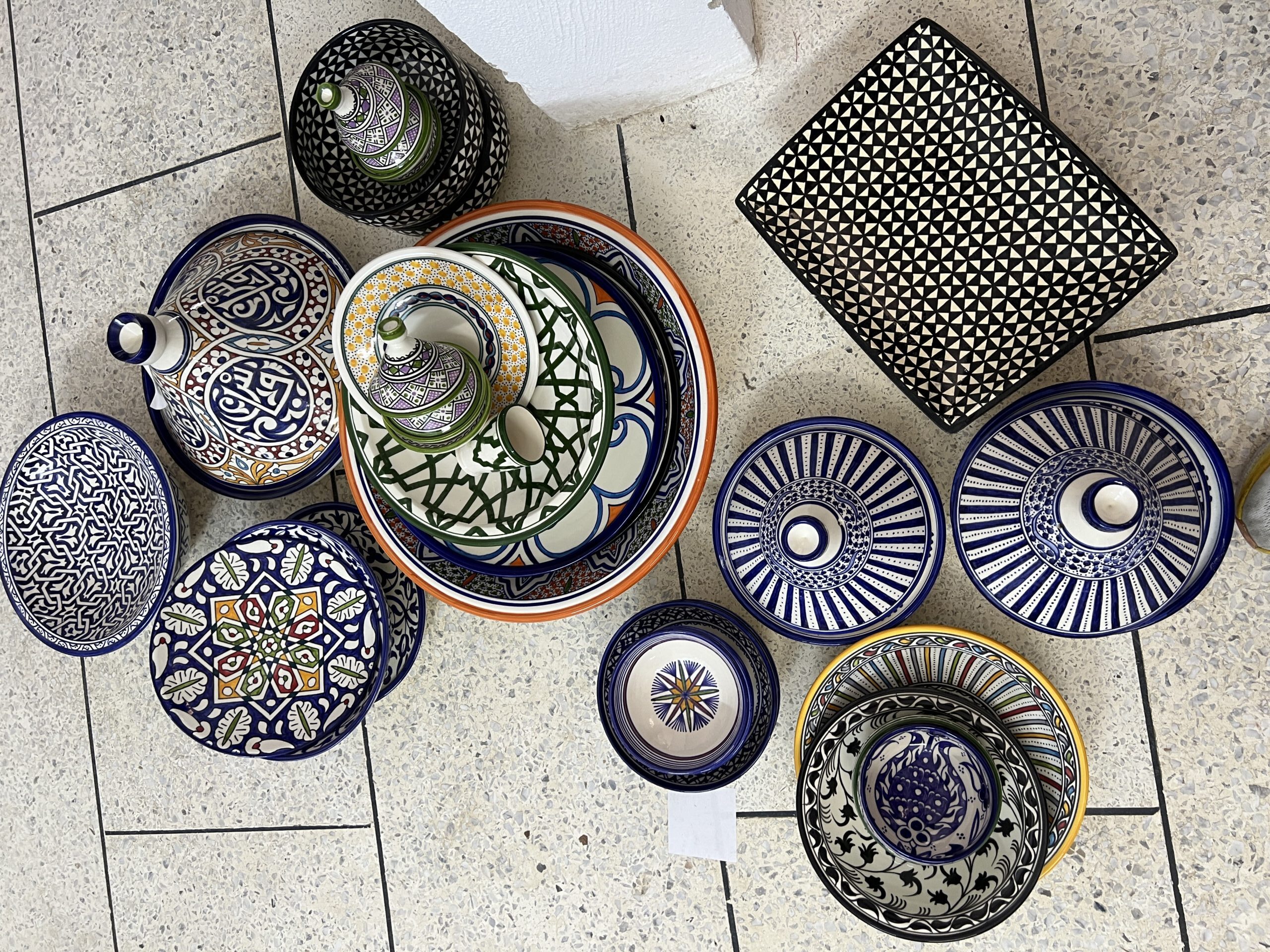 Moroccan tea glasses and Japanese matcha bowl with loose leaf tea display.